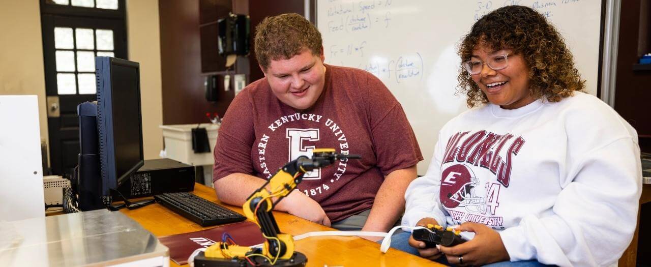 Header image with two EKU Engineering students at table with robotics