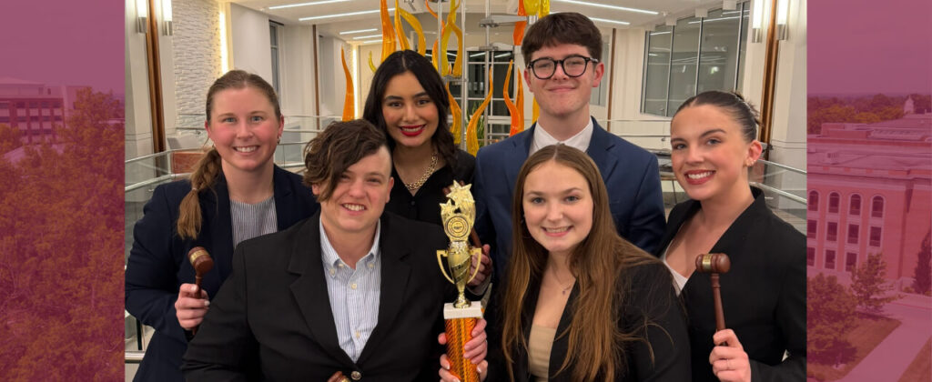 Group of Mock Trial participants posing with trophy