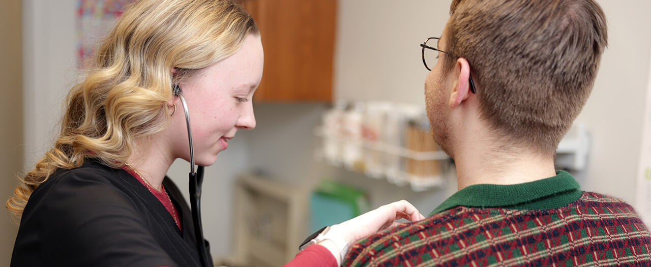 Header image healthcare student listening with a stethoscope