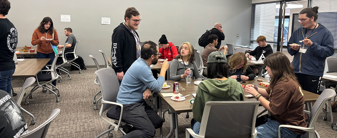 EKU Faculty, Staff, and Students enjoy a break in the symposium to sample pie and discuss the various topics being presented.