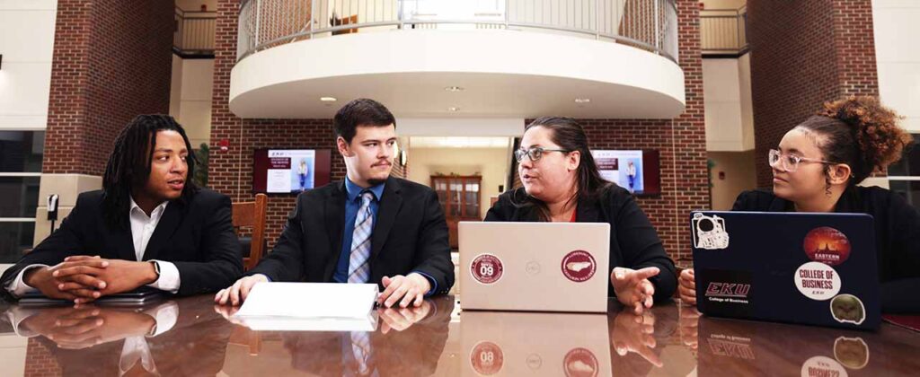 Header image College of Business students at conference table