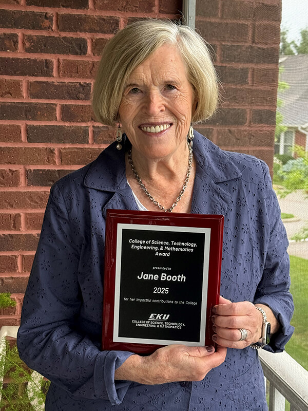 Portrait of Jane Booth holding her CSTEM plaque