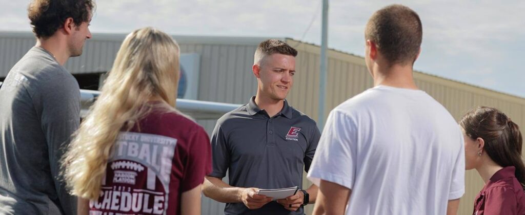 Header image of Aviation students with professor