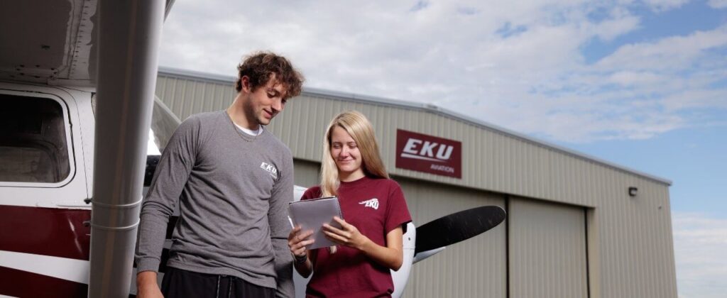 Header image of EKU students in front of airplane hangar.