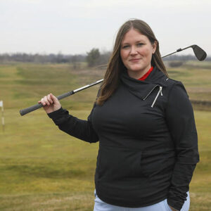 Whitney Paul with a golf club over her shoulder