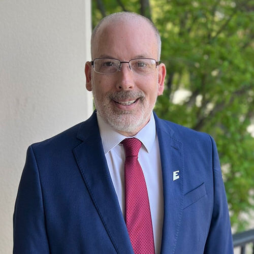 Dr. John Ballard poses outside for a professional photo