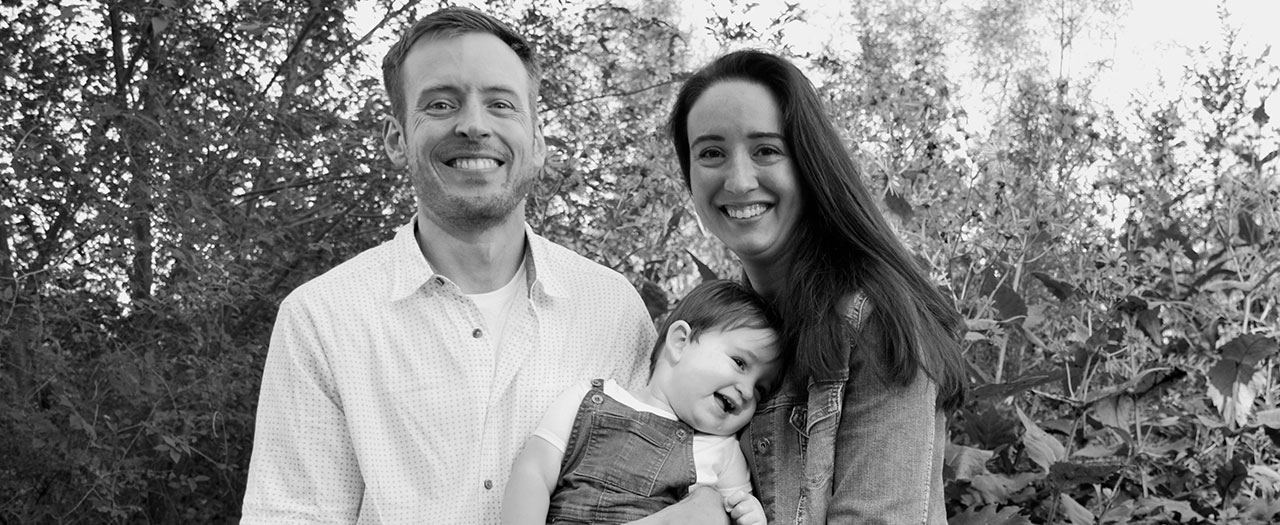 EKU professor smiles with his wife and toddler in a black and white family photo