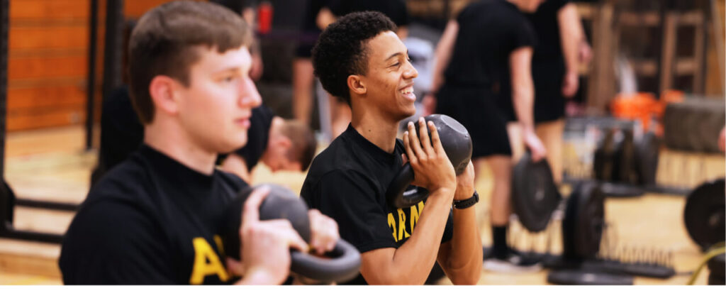 Banner image of two male EKU ROTC students working out in the gym