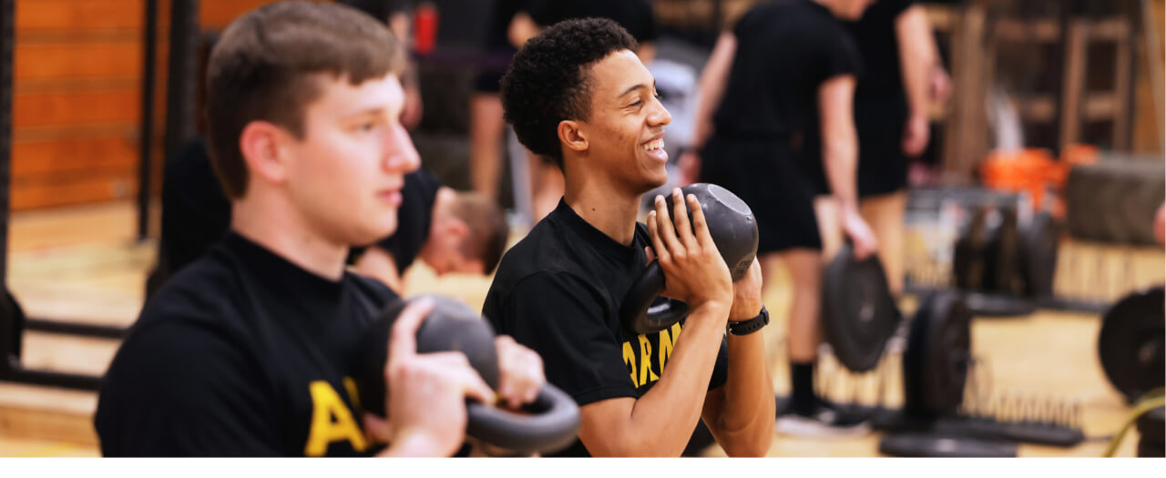 Banner image of two male EKU ROTC students working out in the gym